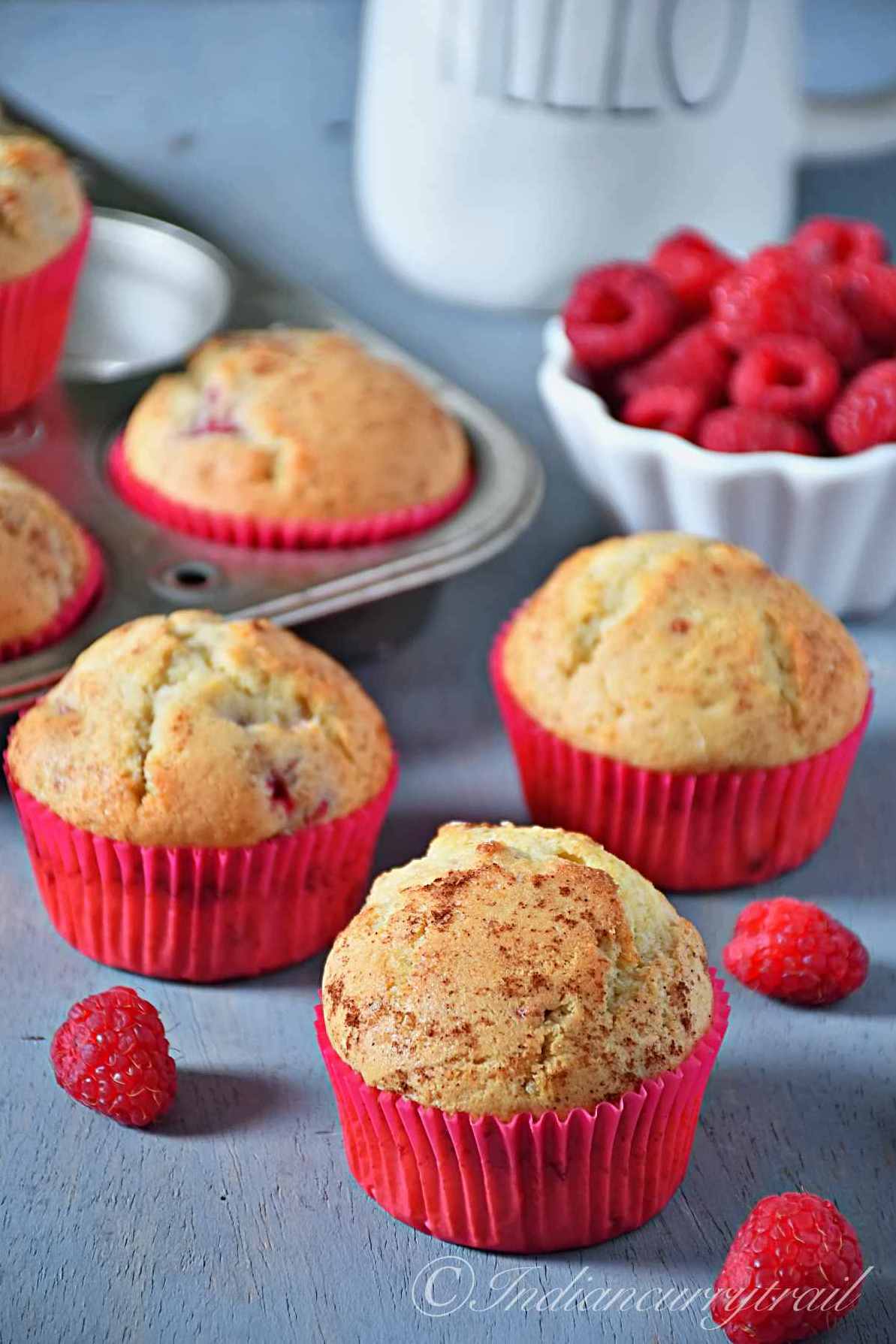 easy homemade raspberry muffins fresh out of the oven and topped with cinnamon sugar