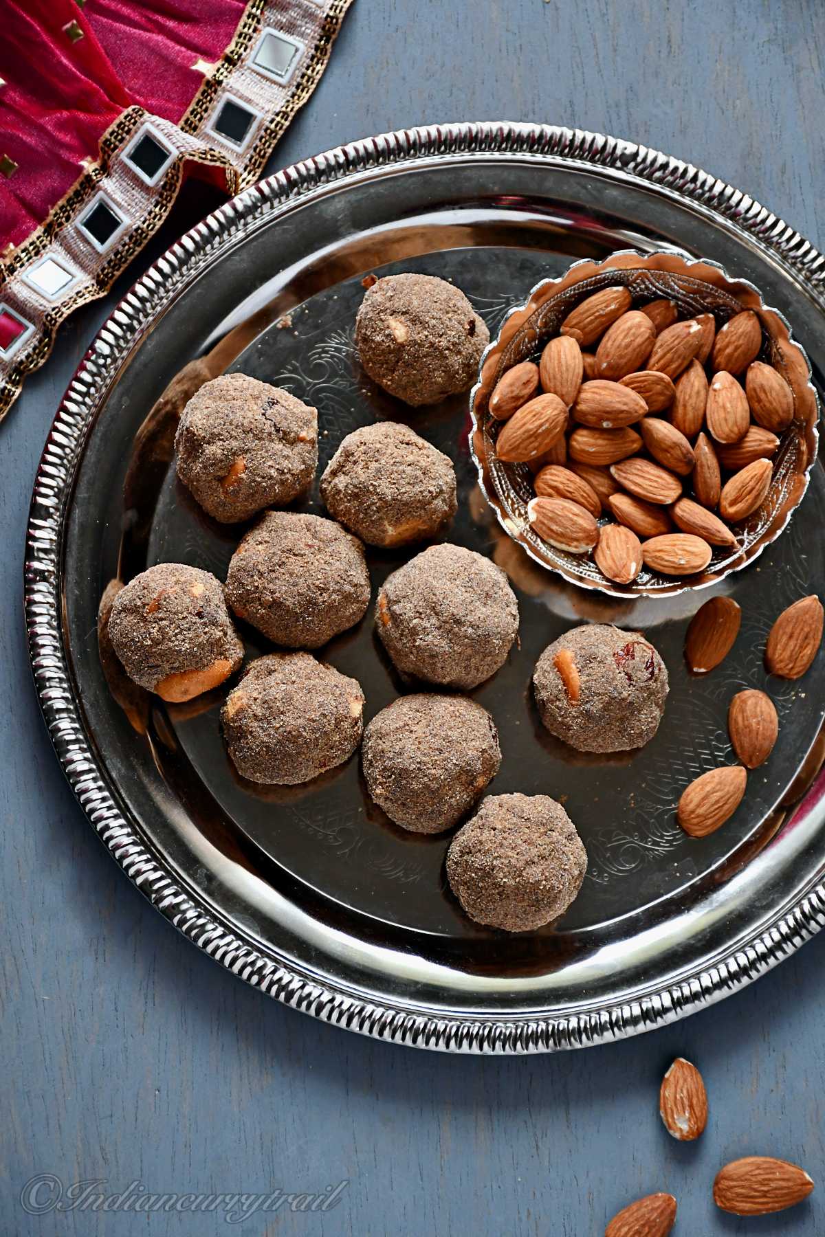 top view of sathu maavu laddu with a bowl of almonds on the side